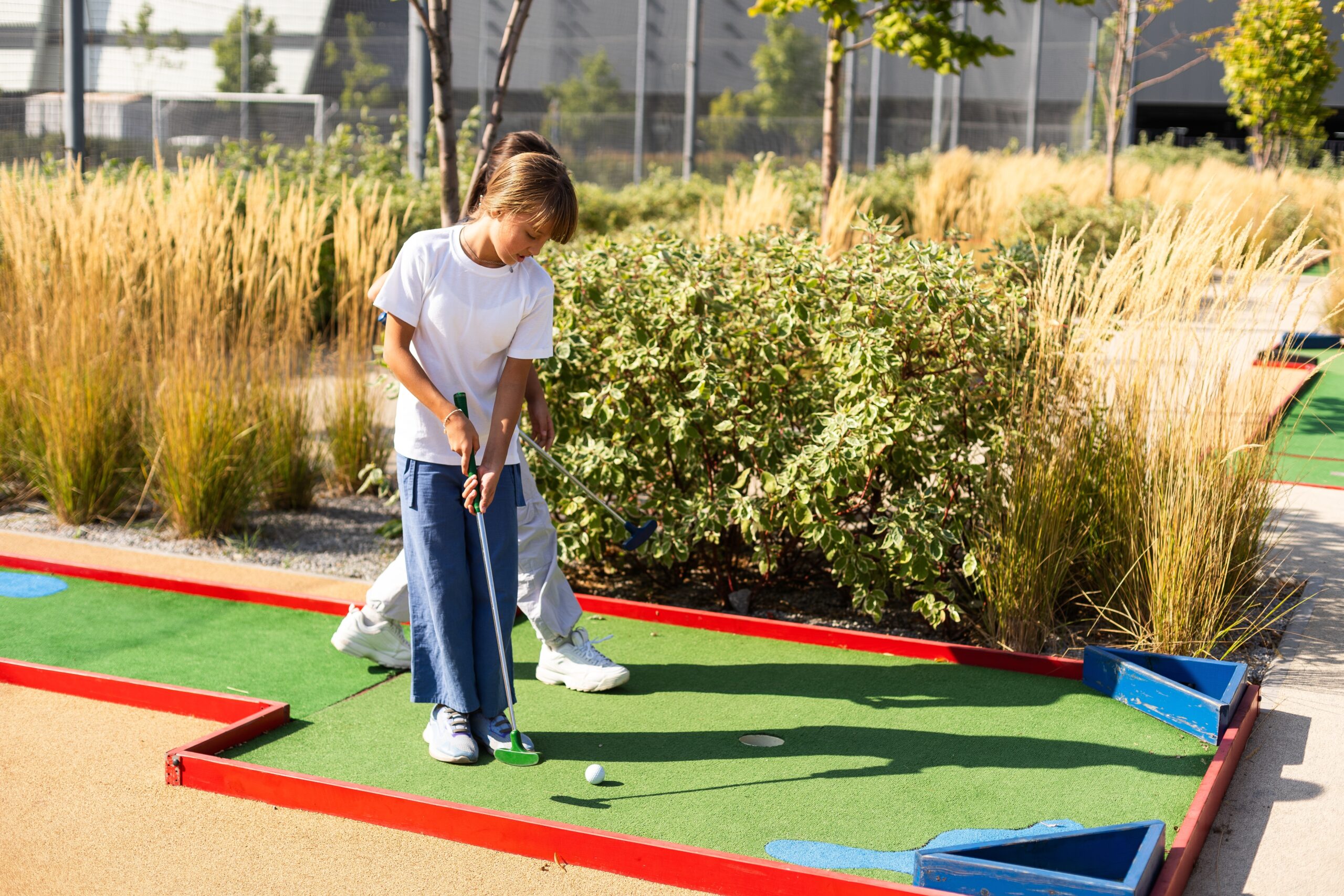 Casual,Kids,At,A,Golf,Field,Holding,Golf,Clubs.,Sunset